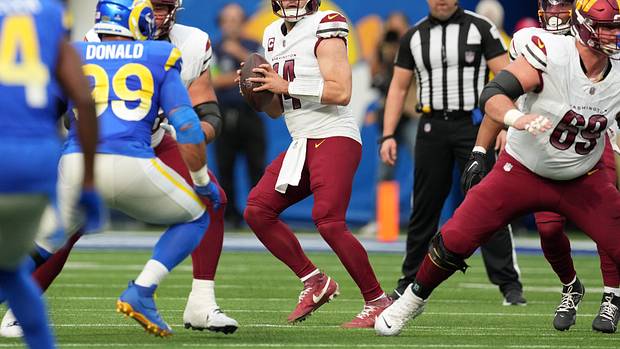 Washington Commanders quarterback Sam Howell (14) throws the ball against the Los Angeles Rams in the first half at SoFi Stadium.