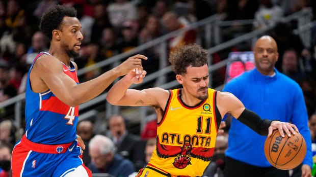 Apr 6, 2022; Atlanta, Georgia, USA; Atlanta Hawks guard Trae Young (11) is defended by Washington Wizards guard Ish Smith (4) during the second half at State Farm Arena.