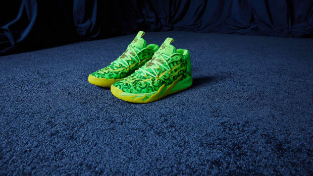 Side view of LaMelo Ball's green and yellow PUMA basketball shoes.