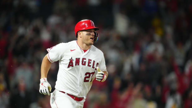 Los Angeles Angels center fielder Mike Trout hits a home run against the Boston Red Sox.