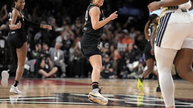 Las Vegas Aces guard Kelsey Plum smiles after a play.