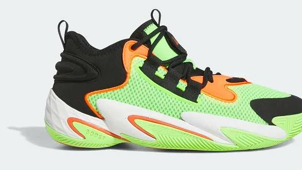 Side view of a green, orange, and black adidas shoe.