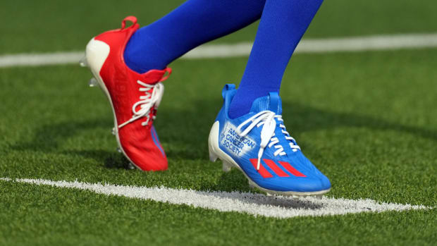 Los Angeles Rams wide receiver Tutu Atwell's red and black adidas cleats.