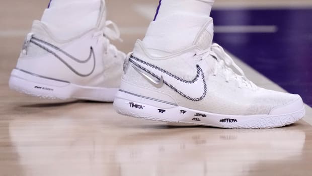View of LeBron James' white Nike shoes.
