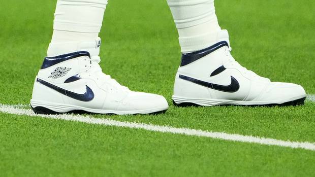 View of Dallas Cowboys quarterback Dak Prescott's white and blue Air Jordan cleats.