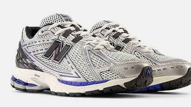 Side view of silver and black New Balance shoes.