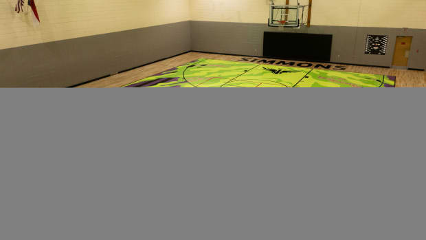 View of a purple and green YMCA basketball court.