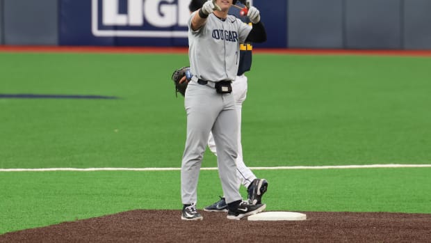 BYU first baseman Cooper Vest points to the Cougars dugout after delivering a double in the fourth inning.