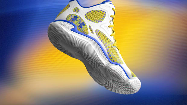 Side view of Stephen Curry's white and gold Under Armour sneakers.