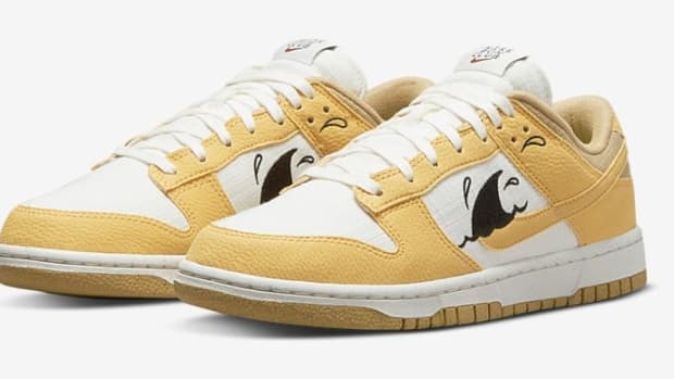 Gold and white Nike Dunk Low shoes.