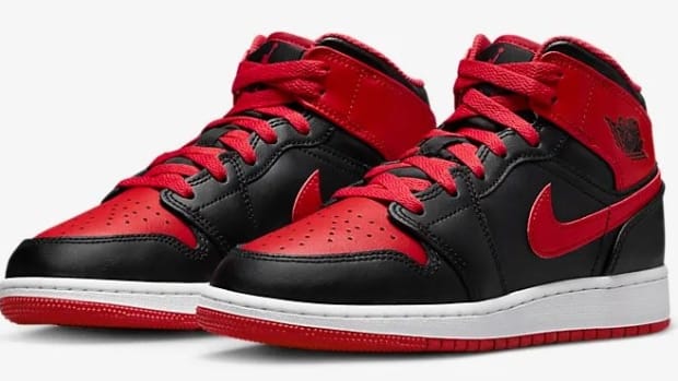 Side view of black and red Air Jordan sneakers.