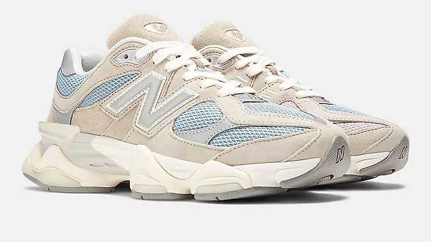 Side view of grey and blue New Balance shoe.