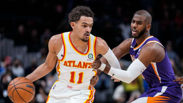 Feb 3, 2022; Atlanta, Georgia, USA; Atlanta Hawks guard Trae Young (11) dribbles against Phoenix Suns guard Chris Paul (3) during the first quarter at State Farm Arena