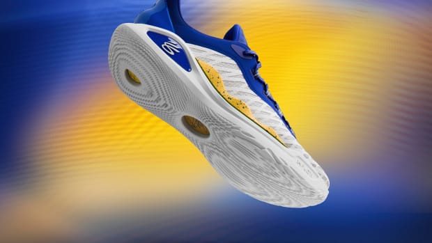 Side view of Stephen Curry's white, blue, and gold sneakers.