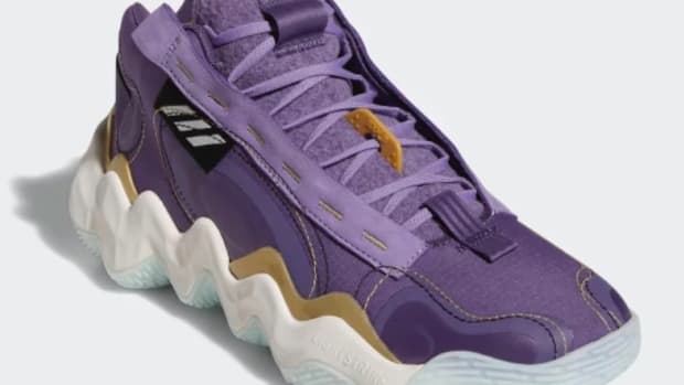 View of purple and white adidas shoe.