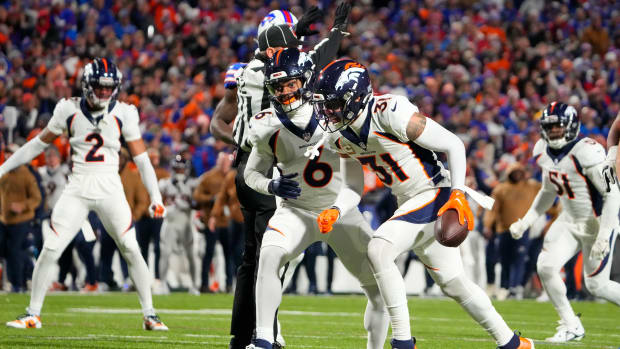 Broncos safety Justin Simmons (31) reacts after intercepting a pass with safety P.J. Locke (6) against the Buffalo Bills during the first half at Highmark Stadium.