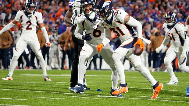 Broncos safety Justin Simmons (31) reacts after intercepting a pass with safety P.J. Locke (6) against the Buffalo Bills during the first half at Highmark Stadium.