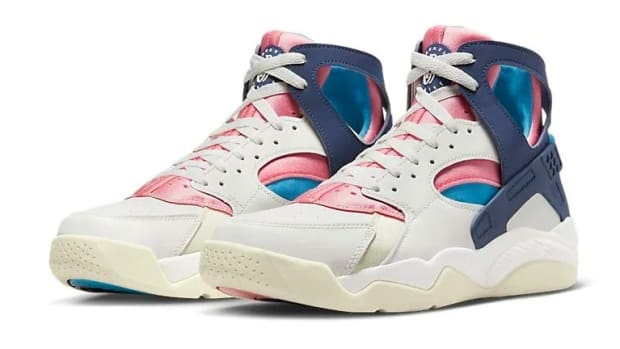 Side view of white, navy, and pink Nike sneakers.