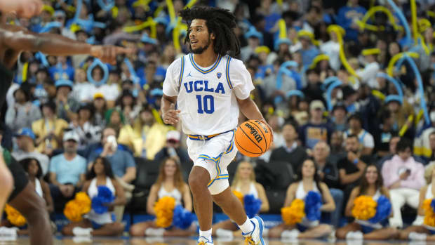 UCLA Bruins guard Tyger Campbell dribbles the ball up the floor.