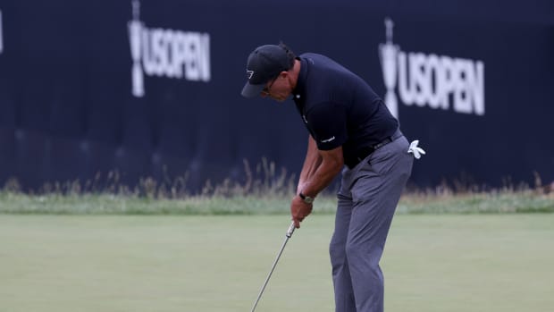 Phil Mickelson putts on the 9th hole during the first round of the U.S. Open golf tournament.
