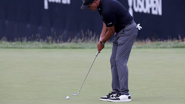 Phil Mickelson putts on the 9th hole during the first round of the U.S. Open golf tournament.