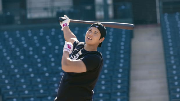Shohei Ohtani swings a baseball bat.