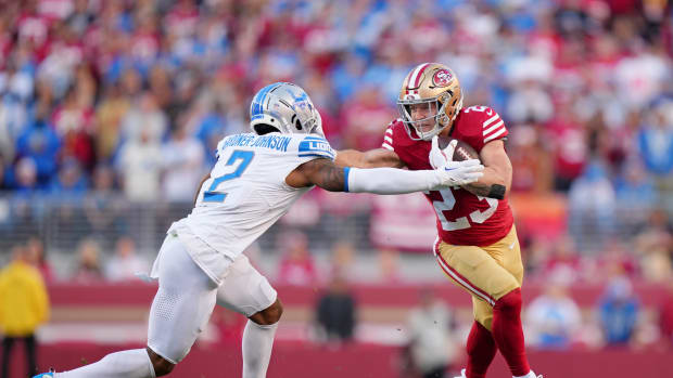 San Francisco 49ers running back Christian McCaffrey stiff-arms Detroit Lions safety C.J. Gardner-Johnson.