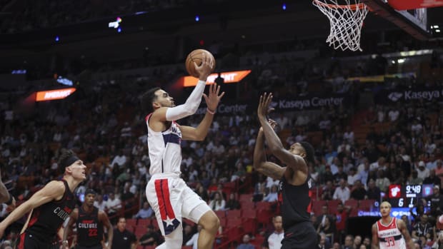Washington Wizards guard Tyus Jones (5) drives to the basket against Miami Heat forward Haywood Highsmith (24) during the first quarter at Kaseya Center.