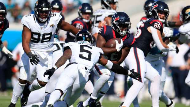 Singletary rushes for yards against Jacksonville Jaguars safety Andre Cisco during the fourth quarter at EverBank Stadium in Jacksonville.