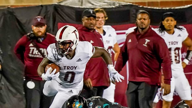 Troy Trojans running back Kimani Vidal (0) is tackled by Coastal Carolina Chanticleers linebacker Mason Shelton (20) at Brooks Stadium.