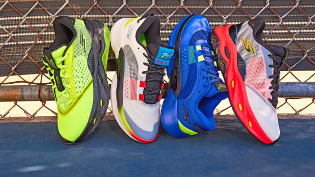 Four multicolor Skechers basketball shoes on an outdoor basketball court.