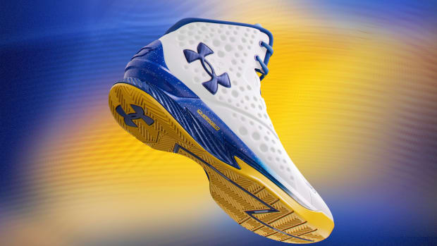 Side view of Stephen Curry's white, blue, and gold Under Armour sneakers.