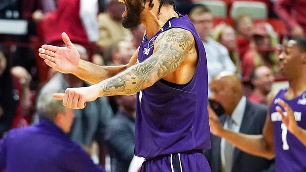 Northwestern Wildcats guard Boo Buie (0) celebrates after defeating the Indiana Hoosiers at Simon Skjodt Assembly Hall.