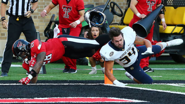 Sep 3, 2022; Lubbock, Texas, USA; Texas Tech Red Raiders running back Tahj Brooks (28) scores against Murray State Racers defensive back Eric Samuta (34) in the first half at Jones AT&T Stadium and Cody Campbell Field. Mandatory