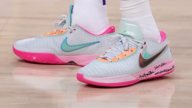 View of pink and green Nike LeBron shoes.