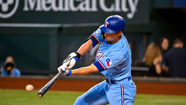 Sep 11, 2022; Arlington, Texas, USA; Texas Rangers shortstop Corey Seager (5) hits a single against the Toronto Blue Jays during the first inning at Globe Life Field. Mandatory Credit: Jerome Miron-USA TODAY Sports