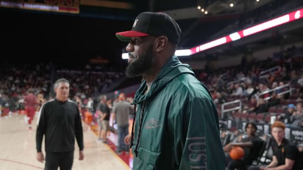 LeBron James watches the game between the USC Trojans and the Washington State Cougars.