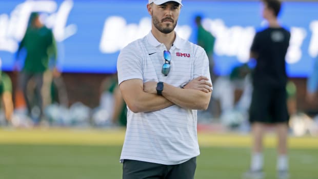 SMU offensive coordinator Garrett Riley watches players practice prior to playing Tulane during an NCAA college football game in Dallas, Thursday, Oct. 22, 2021. (AP Photo/Michael Ainsworth)