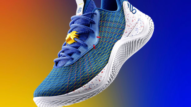 View of blue and white Curry shoe.