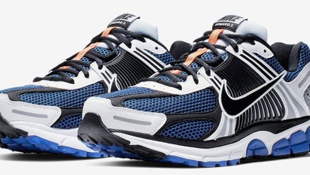 Side view of black, blue, and white Nike running shoes.