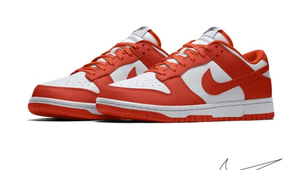 Side view of orange and white Nike Dunk sneakers.
