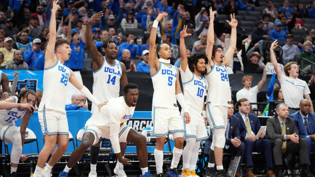The UCLA Bruins bench celebrates during a game.