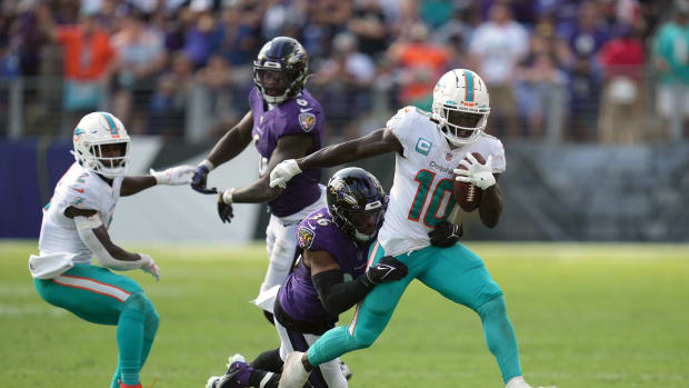 Miami Dolphins wide receiver Tyreek Hill (10) gains yardage after his catch in the fourth quarter defended by Baltimore Ravens safety Chuck Clark (36) at M&T Bank Stadium. Mandatory Credit: Mitch Stringer-USA TODAY Sports