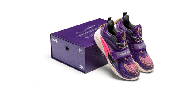 Kyrie Irving's purple ANTA sneakers propped on a box.