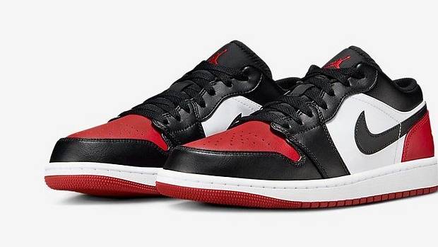 Side view of red and black Air Jordan sneakers.
