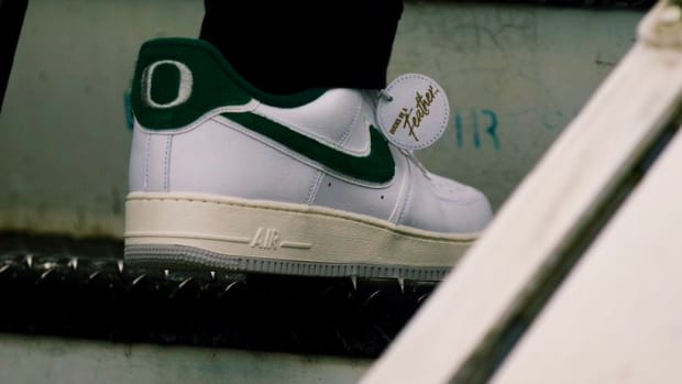 White and green Nike sneakers worn by an Oregon Ducks football player.