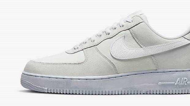 Side view of a white and grey Nike Air Force 1 shoe.