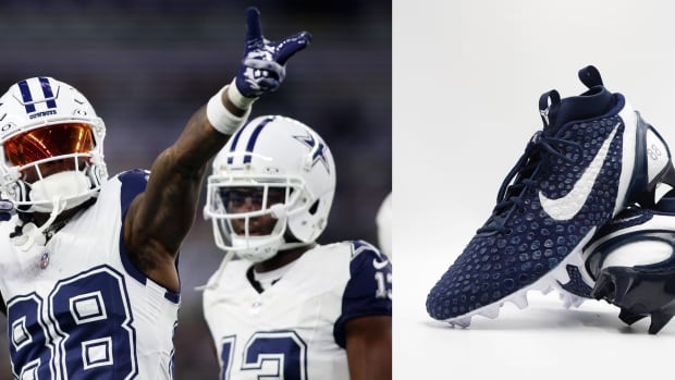 Dallas Cowboys wide receiver CeeDee Lamb points to his navy and white Nike Kobe cleats.
