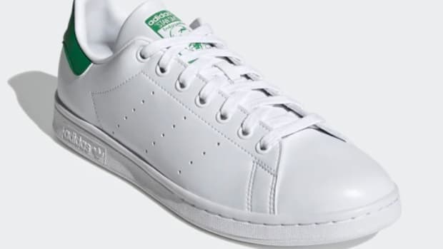 View of white and green adidas shoe.