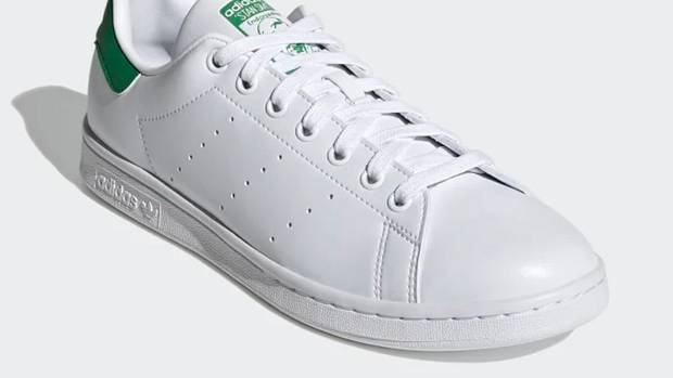 View of white and green adidas shoe.
